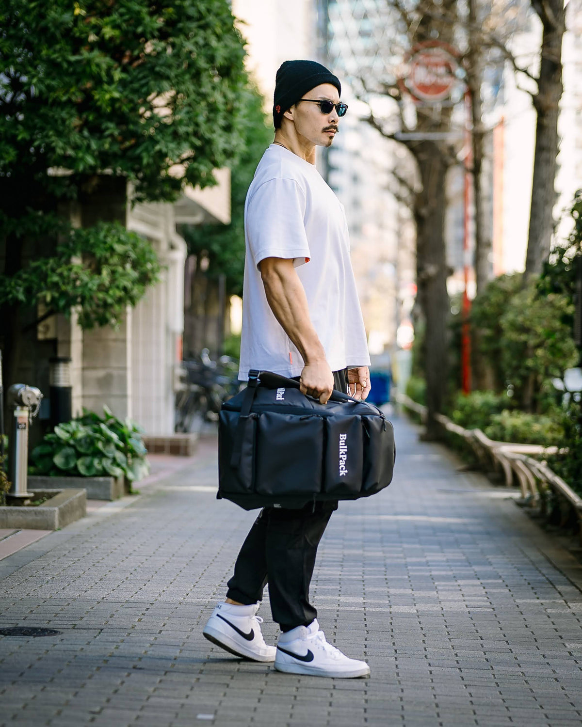 BulkPack を手に持った街での着用イメージ