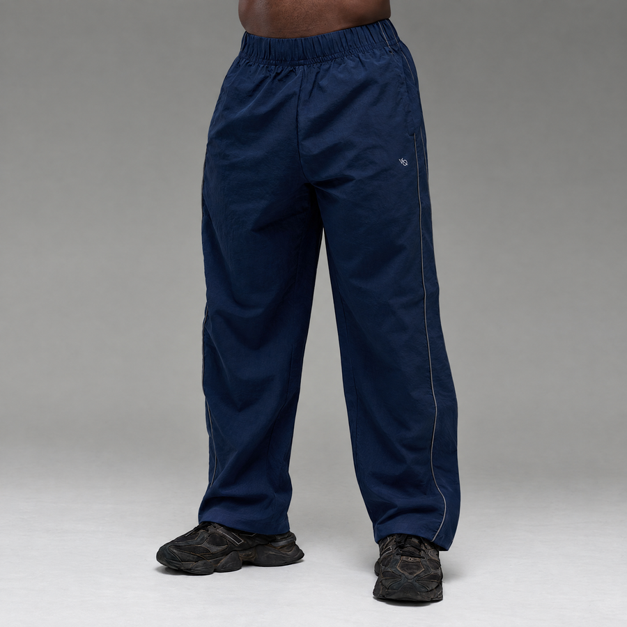 REFLECTIVE NAVY OVERSIZED TRACK PANTS 1枚目の画像